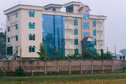 a building with a fence in front of it at Grand Selim Resort & Tour – GSRT in Sreemangal