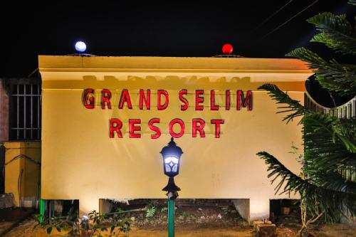 a sign on the side of a building with a street light at Grand Selim Resort & Tour – GSRT in Sreemangal