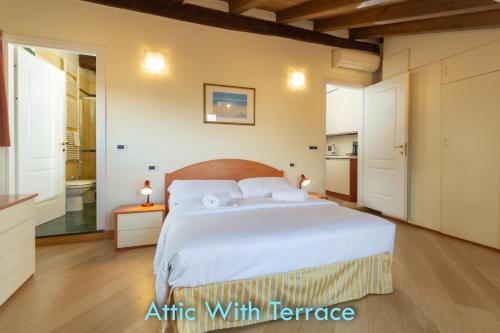 a bedroom with a large bed and a bathroom at BolognaRoomscom - Santo Stefano Apartments in Bologna