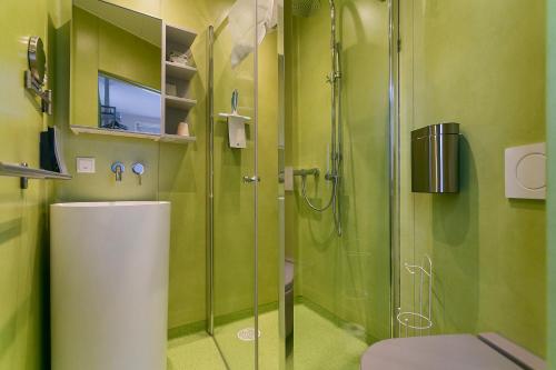 a green bathroom with a shower and a toilet at Bed & Breakfast Marrum in Marrum