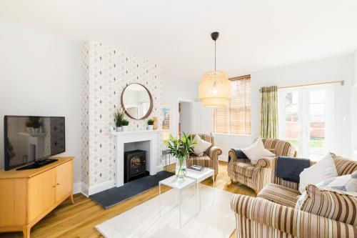 a living room with a couch and a fireplace at Grundy's Lane Apartments in Malvern Wells