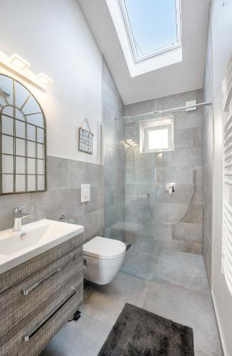 a bathroom with a toilet and a sink and a shower at Jully apartment with swimming pool in Babino Polje