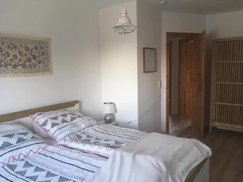 a bedroom with a large bed with white walls at Ferienhaus Elisenhuus in Tönning