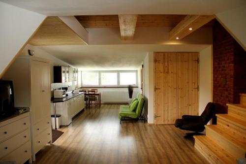a room with a kitchen and a living room at Penzion Stará sokolovna in Šumperk