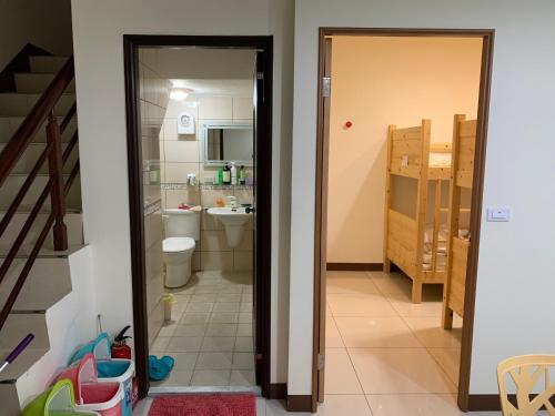 a bathroom with a sink and a toilet in a room at Gardens by the bay in Taitung City