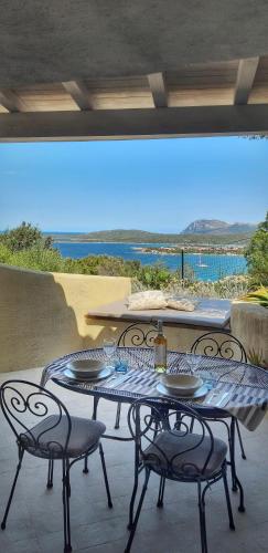 a table and chairs on a patio with a view at Villa Khepri in Porto Rotondo