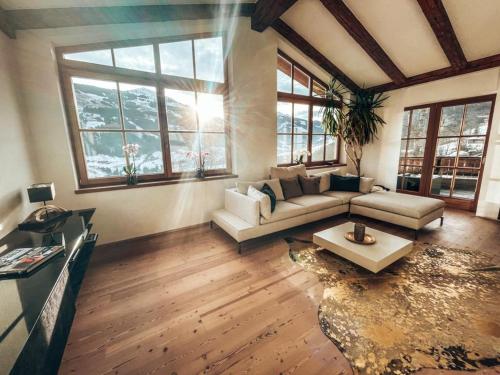 a living room with a couch and a table at Residenz am Berg in Jochberg