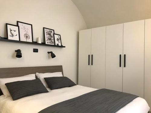 a bedroom with a bed and white cabinets at Rossi21 in Cuneo