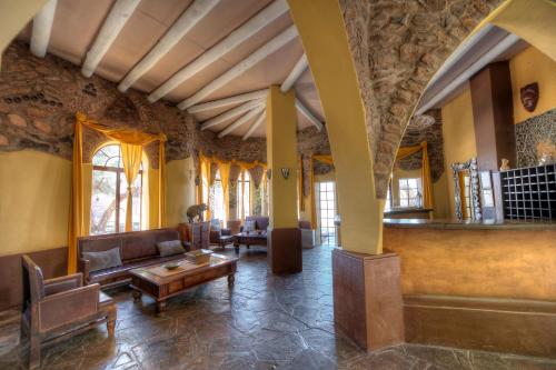a living room with a couch and a table at Le Mirage Resort & Spa in Sesriem