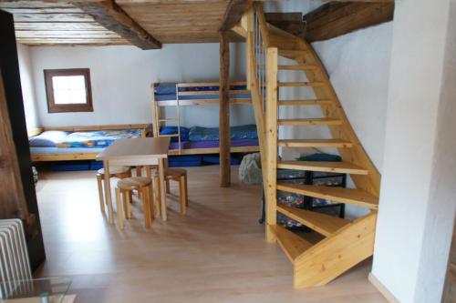 a room with two bunk beds and a staircase at Chalet Edelweiss in Hérémence