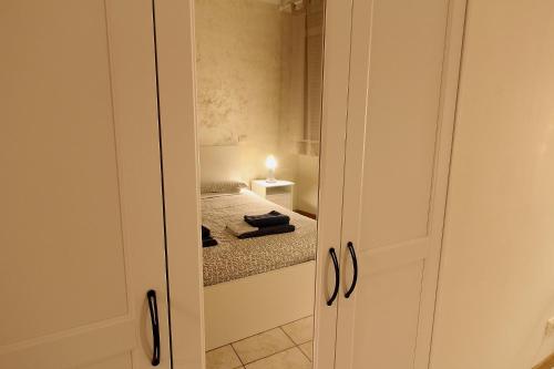 a small bedroom with a bed and a closet at La casa del Darda 3 in Ancona