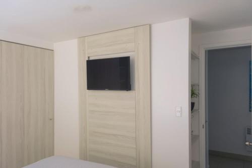 a bedroom with a sliding door with a tv on it at Vista Abanico in Maitencillo