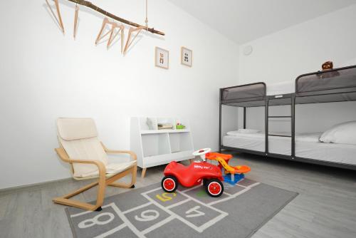 a room with two bunk beds and a toy car on a rug at StayCozy Bike&Ski Apartments, barrierefrei, free WIFI, Erdgeschoss in Winterberg