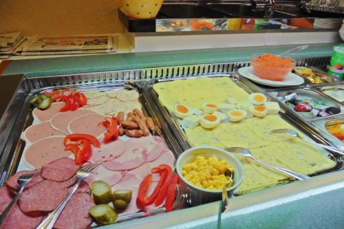 a display case with many different types of food at Hotel Kriemhilde in Worms