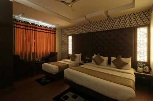 a hotel room with two beds and a window at Hotel Mannat international by Mannat in New Delhi