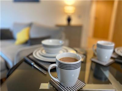 a cup of coffee sitting on a glass table at Apartment A321 in Northampton