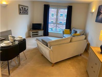 a living room with a couch and a table at Apartment A321 in Northampton