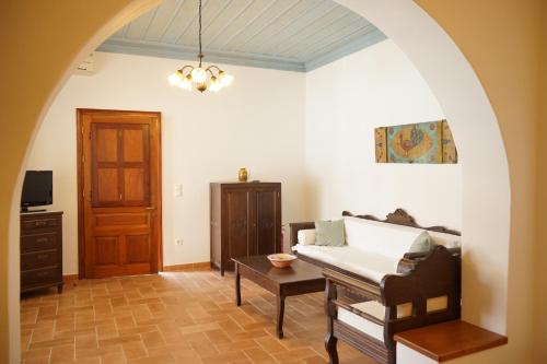 a living room with a couch and a table at Patmos Houses in Patmos