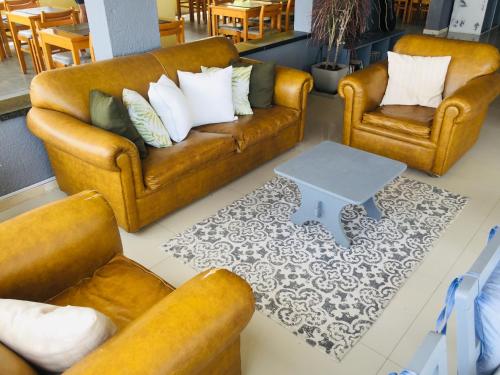a living room with two couches and a table at San Remo Terrazas Hotel in Piriápolis