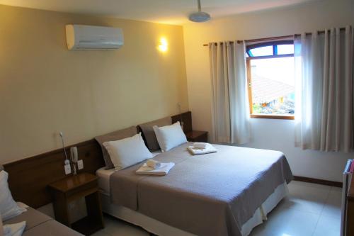Cama ou camas em um quarto em Pousada Recreio Da Praia