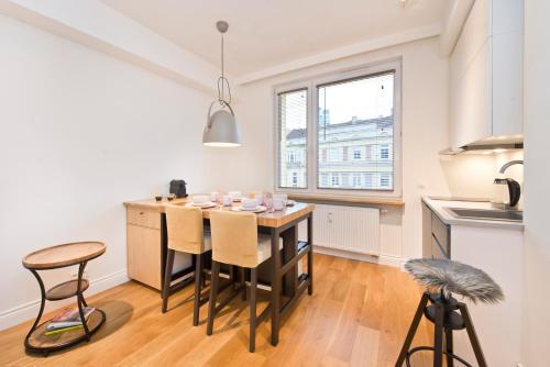a kitchen with a table and chairs in a room at Apartament Świętojańska in Gdynia
