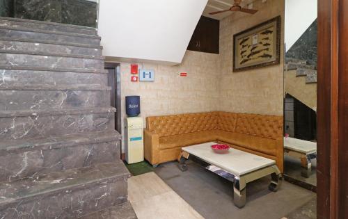 a living room with a couch and a table at Hotel Mannat international by Mannat in New Delhi