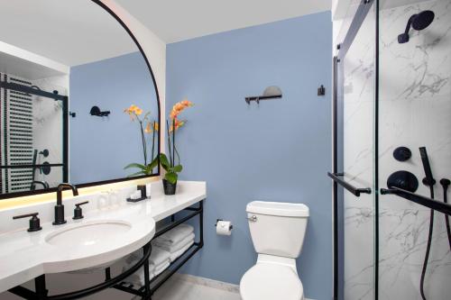 a bathroom with a sink and a shower at The Don CeSar in St Pete Beach