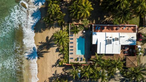 an overhead view of a beach with a resort and the ocean at Casa Isleña in Rincon