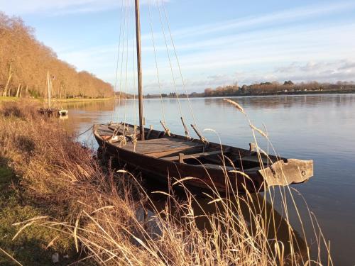 a boat sitting in the water on a lake at Chantilly ,petit déjeuner et table d'hôtes possible in Noyers
