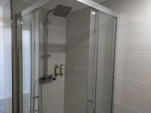 a shower with a glass door in a bathroom at Apartment - Vista Alegre in Ponte de Lima