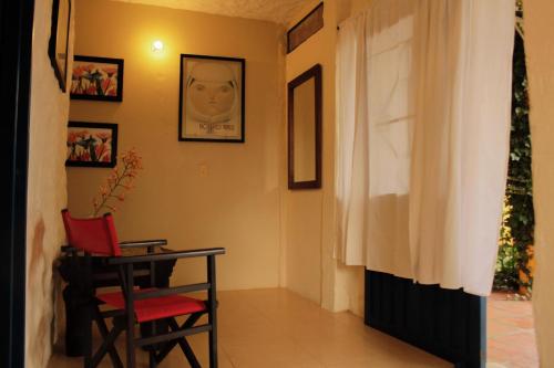 a room with a table and a chair and a window at Casa Encuentro Ecolodge, Outdoor Gym and Yoga in Guatapé