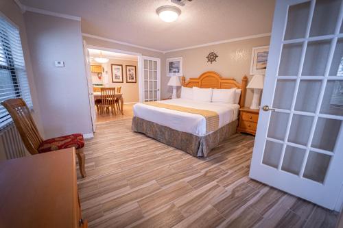 a bedroom with a bed and a dining room at Dockside Inn & Resort in Fort Pierce