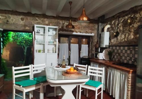 a kitchen with a table and chairs in a room at Casa Nani in Benaocaz