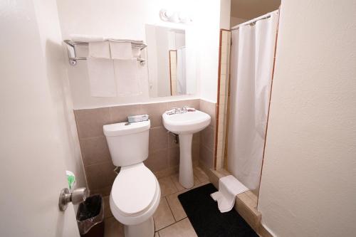 a small bathroom with a toilet and a sink at Stay Inn Suite in Stockton