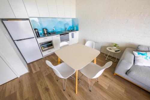 a small living room with a white table and chairs at Max's Beachside Holiday Home in Torquay