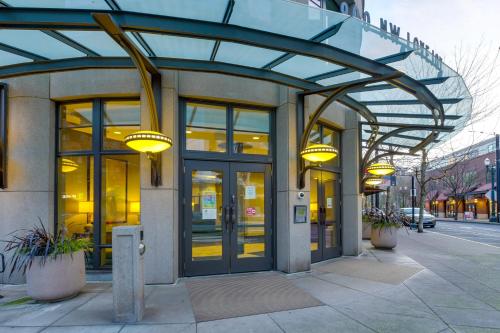 a building with glass doors and lights on a sidewalk at Renu Suites at The Burlington Portland in Portland