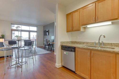 a kitchen with wooden cabinets and a counter top at Renu Suites at The Burlington Portland in Portland