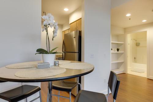 a kitchen with a table with chairs and a refrigerator at Renu Suites at The Burlington Portland in Portland