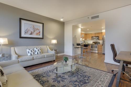 a living room with a couch and a table at Renu Suites at The Burlington Portland in Portland
