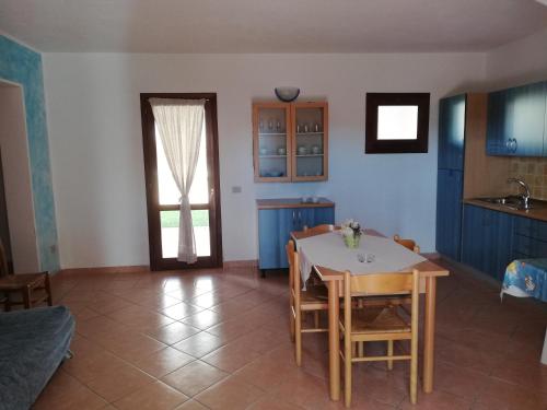 a kitchen and dining room with a table and chairs at Residence Stella Marina in San Teodoro