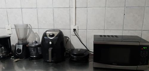 a kitchen counter with a blender and a microwave at Adonai Copacabana Rooms 01 in Rio de Janeiro