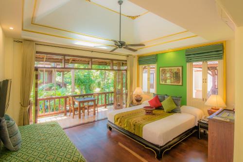 a bedroom with a bed and a balcony at Rabbit Resort Pattaya in Pattaya South