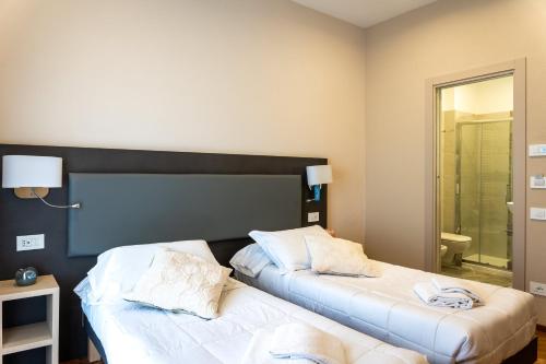 two beds sitting next to each other in a room at Hotel Victoria in Cuneo