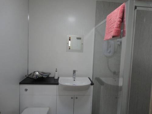 a white bathroom with a sink and a toilet at Appin Lodge in Aviemore