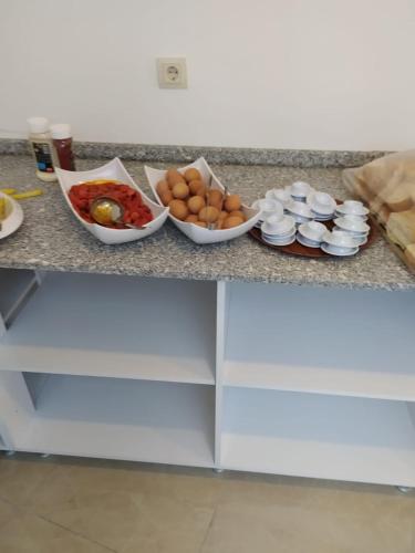 a counter top with bowls of food on it at Asmir Suites Hotel in Nevsehir
