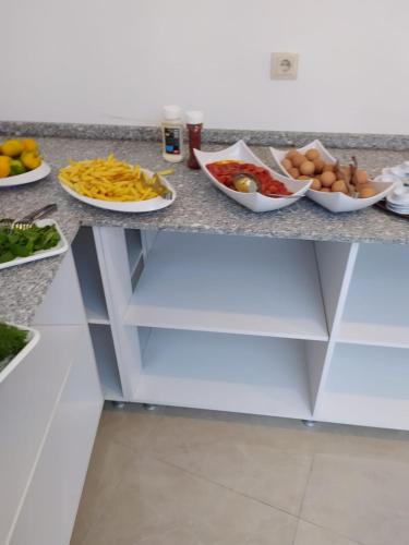 a counter top with plates of food on it at Asmir Suites Hotel in Nevsehir