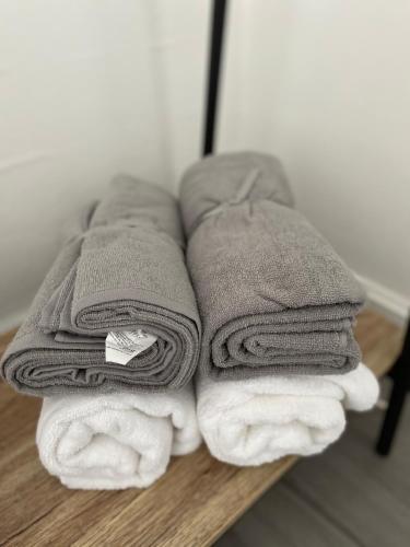 a pile of towels sitting on top of a table at Union Street Apartment in Hawick