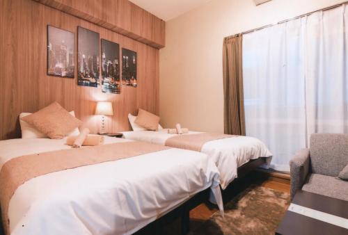 Кровать или кровати в номере Sakura Sands Hotel