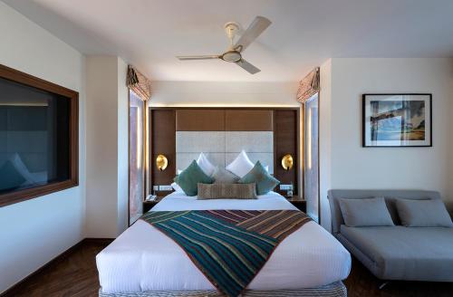 a bedroom with a large bed and a couch at juSTa Mukteshwar Retreat & Spa in Mukteswar