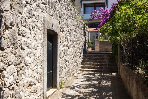 a stone building with stairs leading up to a door at Apartment Garden M&M in Dubrovnik